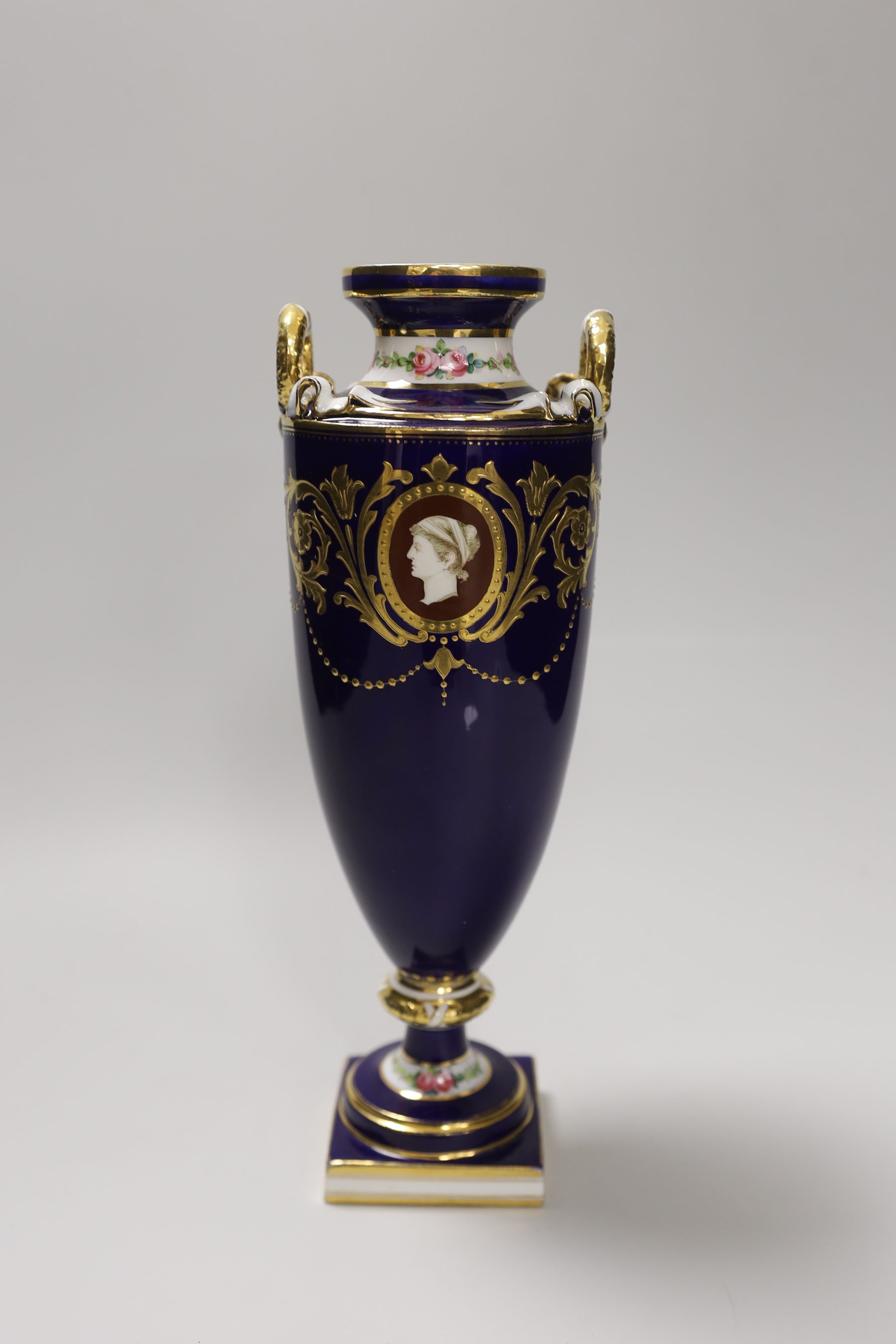 A Minton two handled vase painted with portrait medallions on a blue and gilt ground, 28cm high
